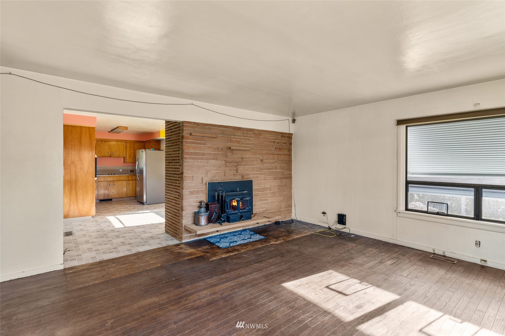 2309 Northeast 9th Street Renton, WA 98056 - Photo 5 of 22 a view of an empty room with a fireplace and a window