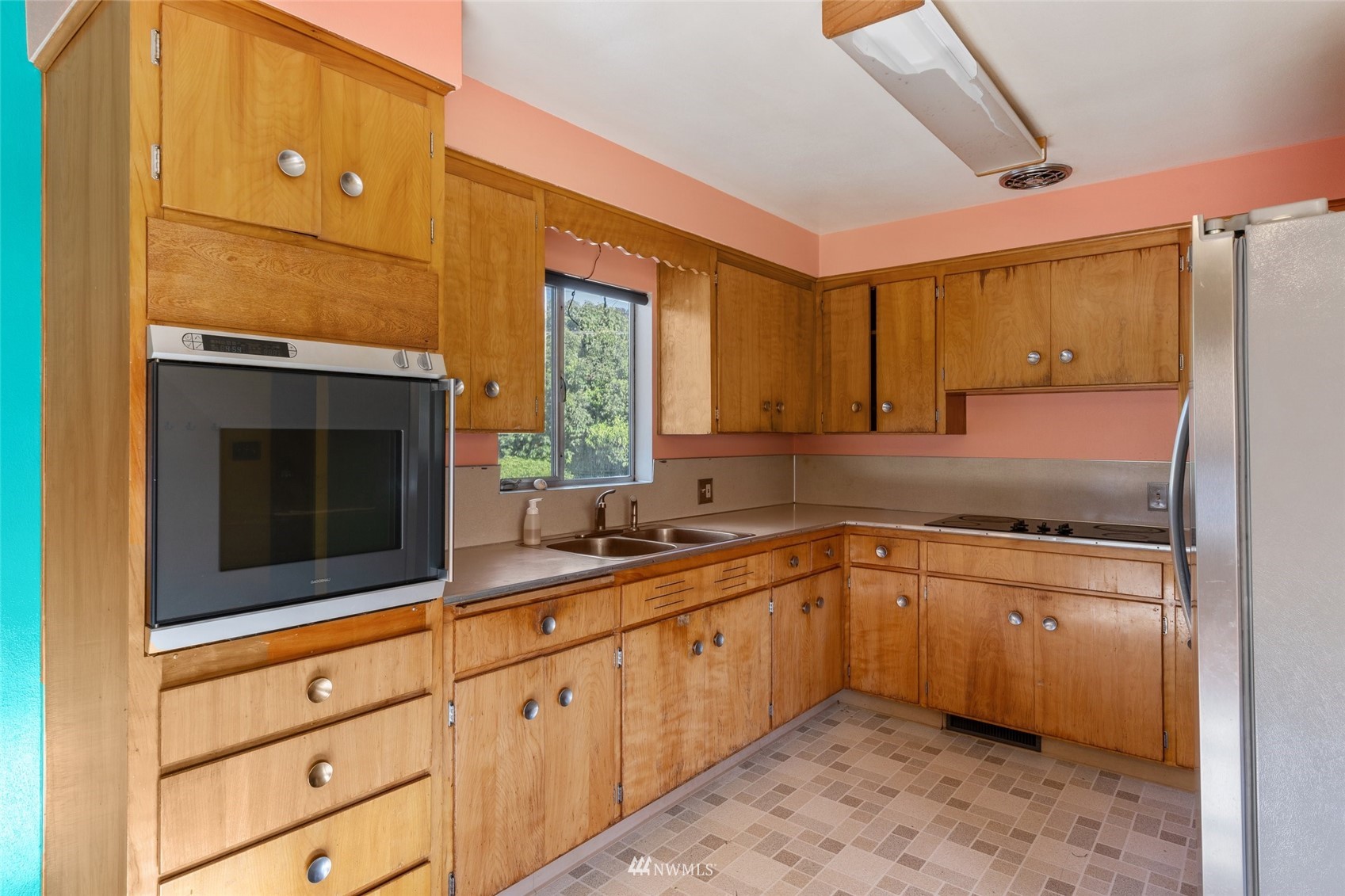 2309 Northeast 9th Street Renton, WA 98056 - Photo 8 of 22 a kitchen with a sink stove and cabinets