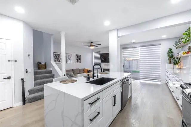 a kitchen with a sink stove and cabinets