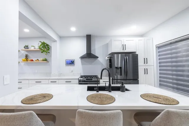 a kitchen with a table chairs and a stove top oven