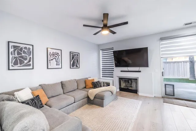 a living room with furniture fireplace and flat screen tv