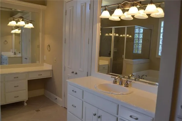 a bathroom with a sink mirror and vanity