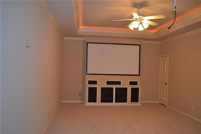a view of a livingroom with a chandelier fan