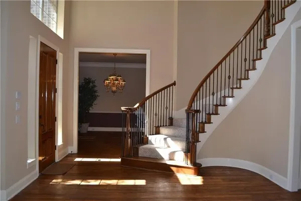 a view of entryway and hall with wooden floor