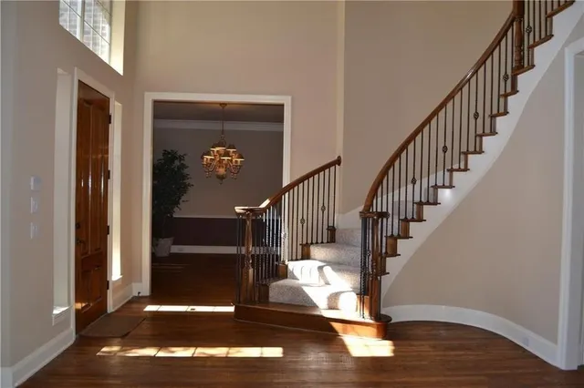 a view of entryway and hall with wooden floor