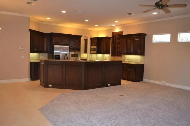 a kitchen with stainless steel appliances a sink and cabinets