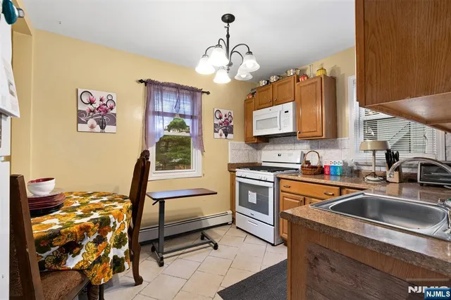 a kitchen with stainless steel appliances granite countertop a refrigerator and a stove