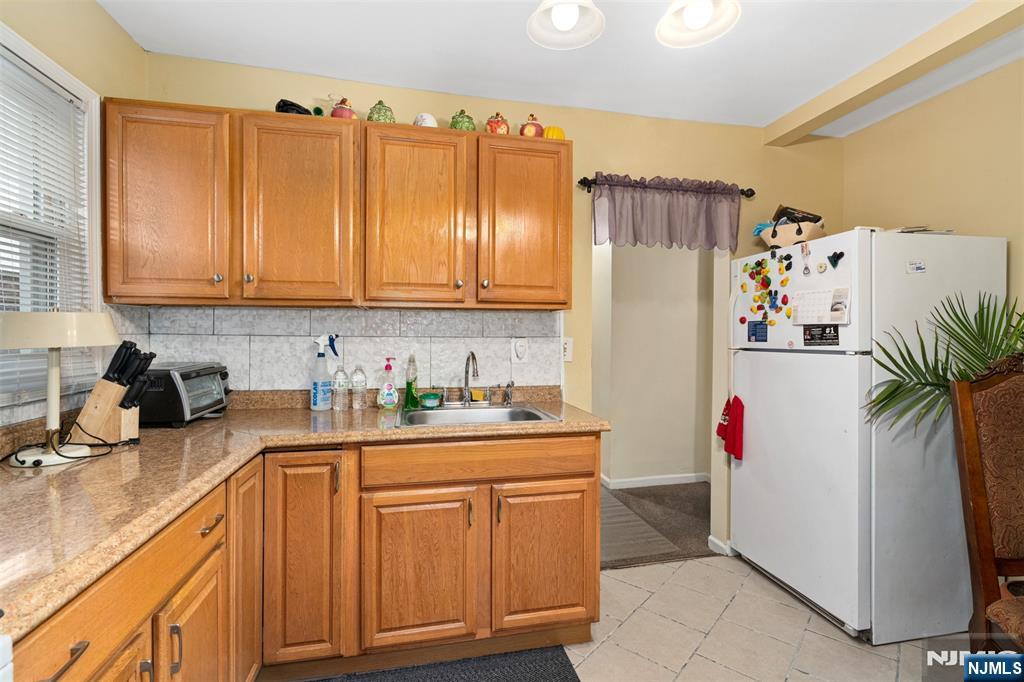 53 Poplar Avenue Hackensack, NJ 07601 - Photo 14 of 15 a kitchen with stainless steel appliances granite countertop a refrigerator and a stove