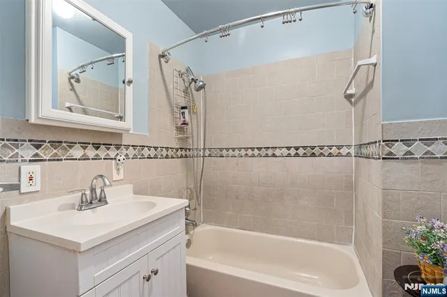 a bathroom with a sink a mirror and a bathtub