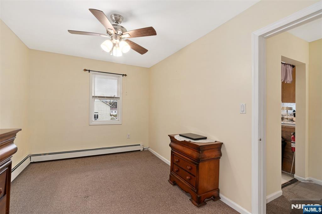 53 Poplar Avenue Hackensack, NJ 07601 - Photo 4 of 15 an empty room with windows and ceiling fan
