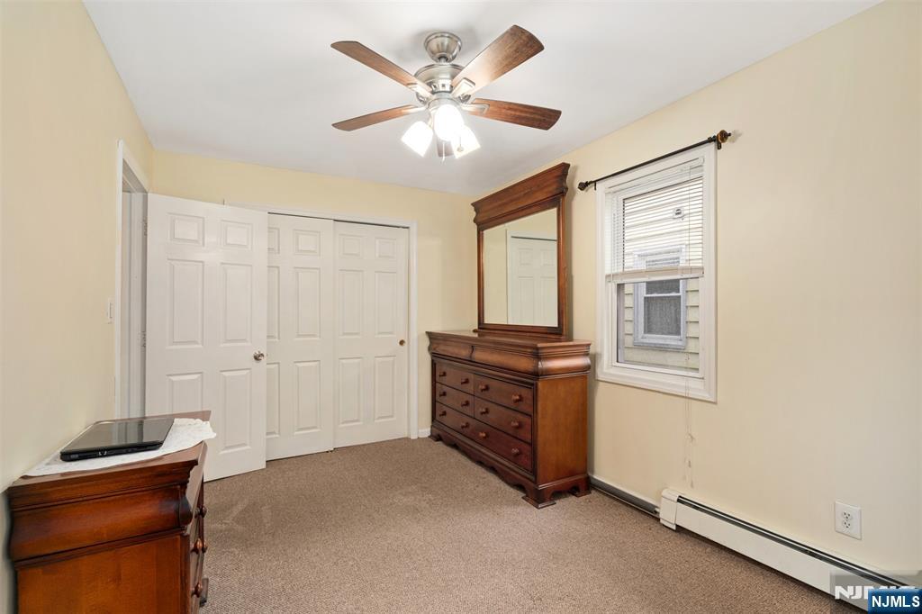 53 Poplar Avenue Hackensack, NJ 07601 - Photo 5 of 15 a view of an empty room with a ceiling fan and a window