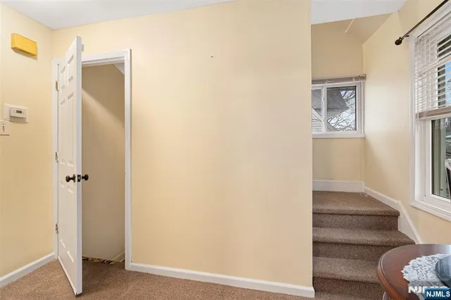 a view of front door with hallway and stairs