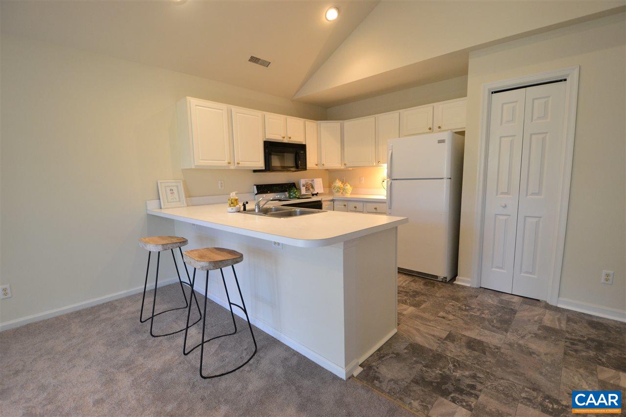 4757 Clover Ridge Court Charlottesville, VA 22901 - Photo 5 of 18 a kitchen with a refrigerator a stove a microwave and island
