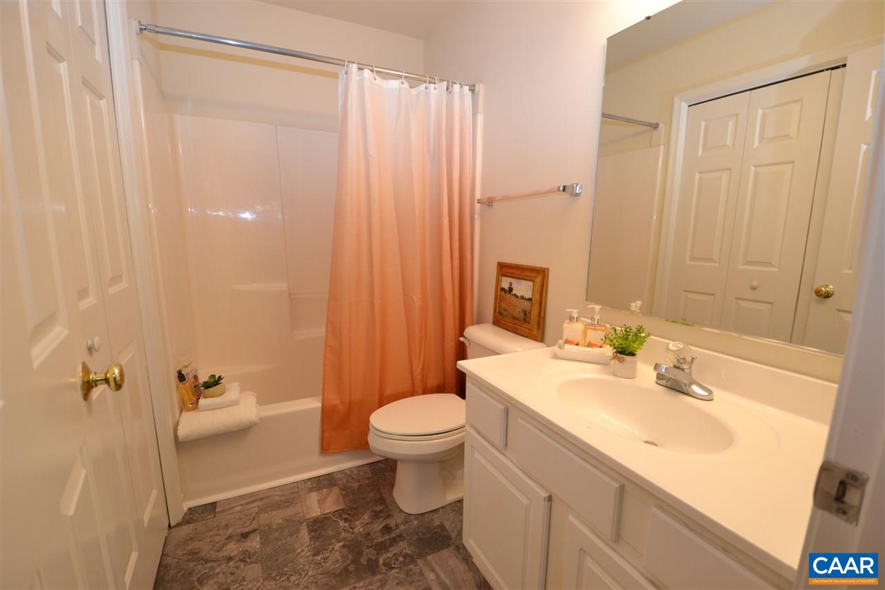 4757 Clover Ridge Court Charlottesville, VA 22901 - Photo 9 of 18 a bathroom with a sink a toilet and shower curtain