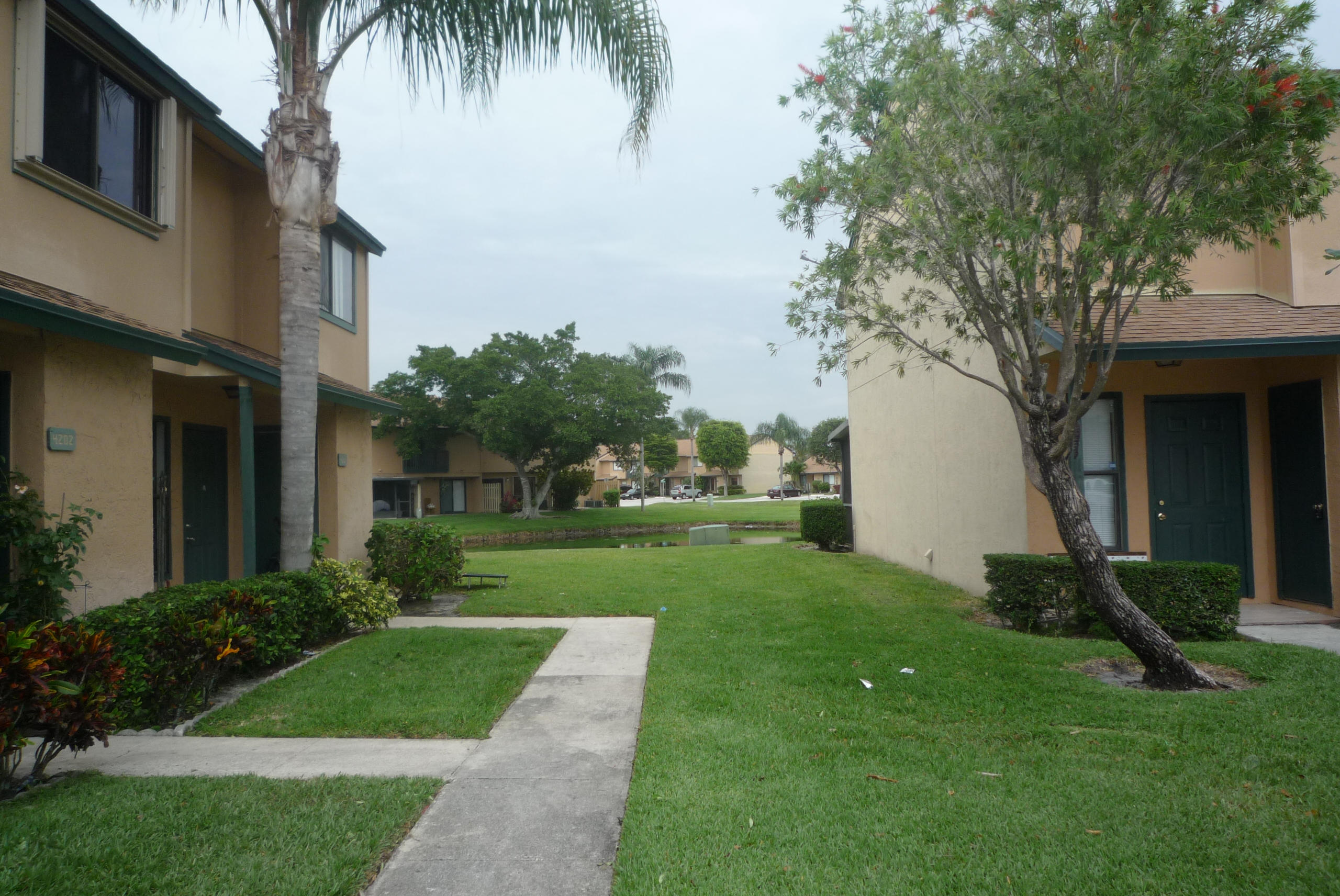4203 Inlet Circle Greenacres, FL 33463 - Photo 2 of 9 a view of a house with a yard