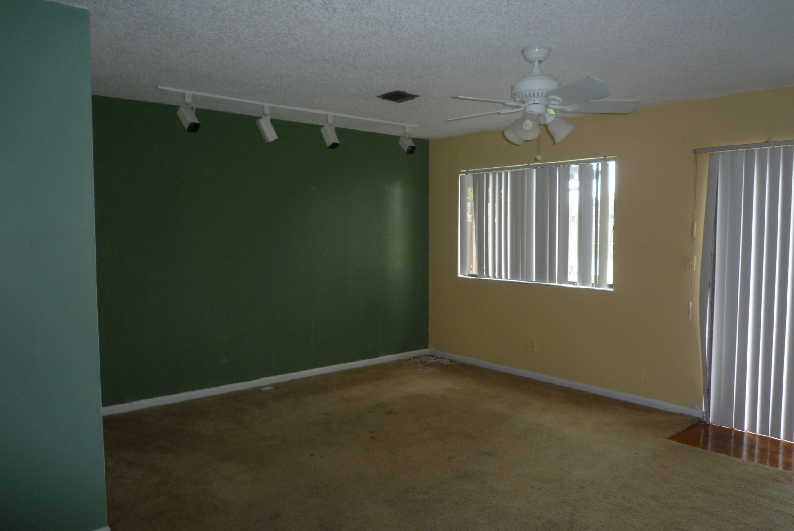 4203 Inlet Circle Greenacres, FL 33463 - Photo 6 of 9 a view of livingroom with window and chandelier fan