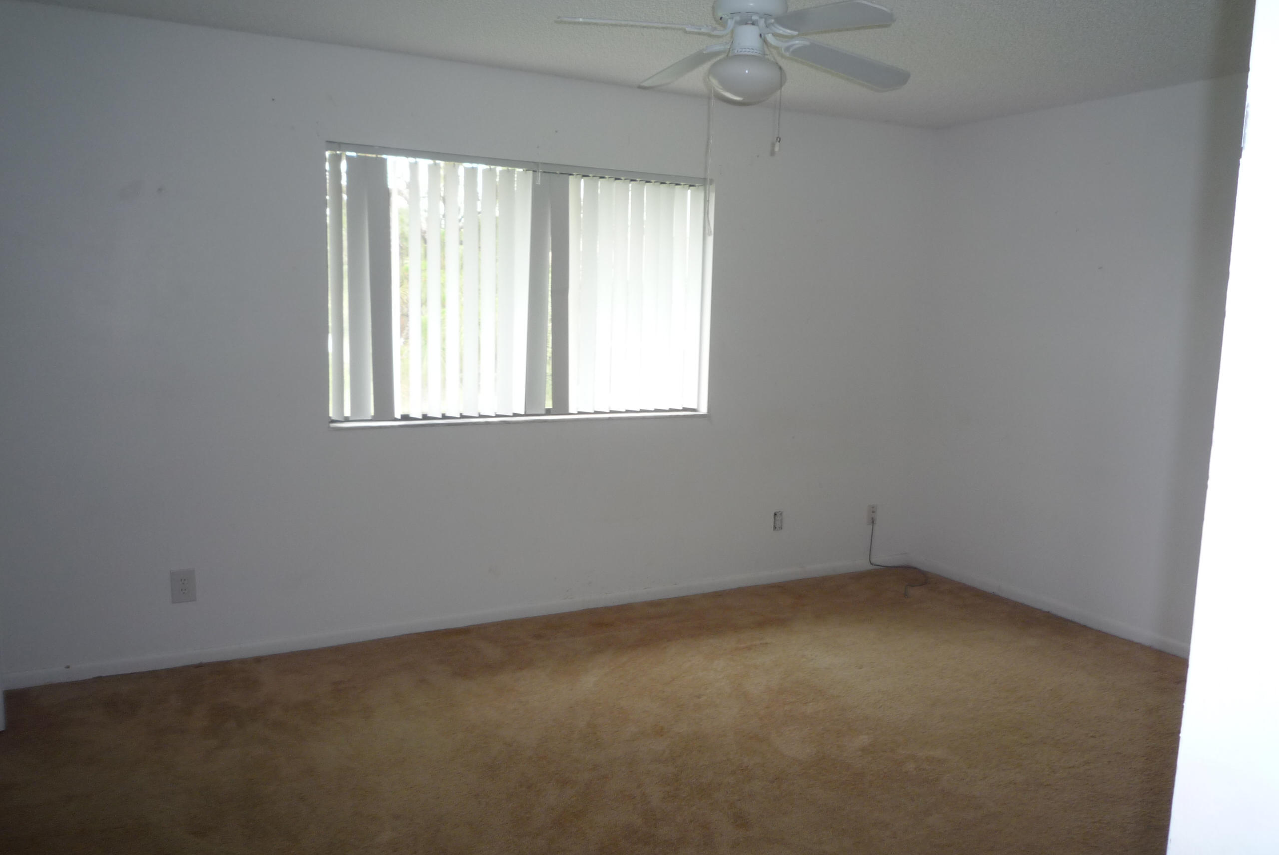 4203 Inlet Circle Greenacres, FL 33463 - Photo 8 of 9 an empty room with a window