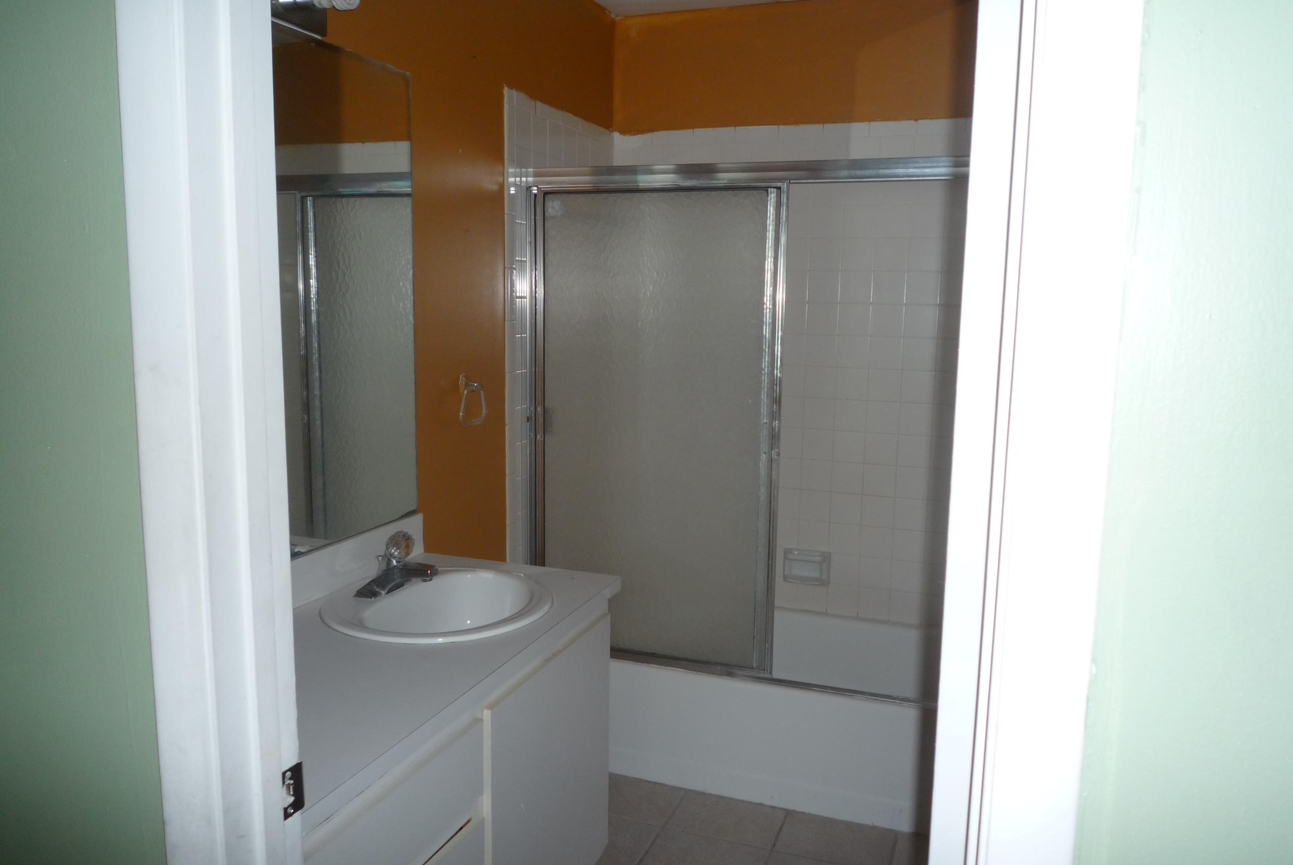 4203 Inlet Circle Greenacres, FL 33463 - Photo 9 of 9 a bathroom with a sink and mirror