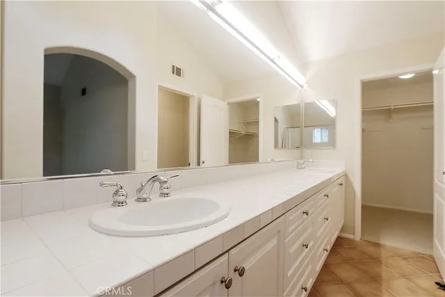 a bathroom with a double vanity sink and a mirror
