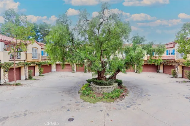 an aerial view of multiple houses with yard