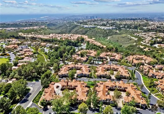 an aerial view of residential houses with outdoor space