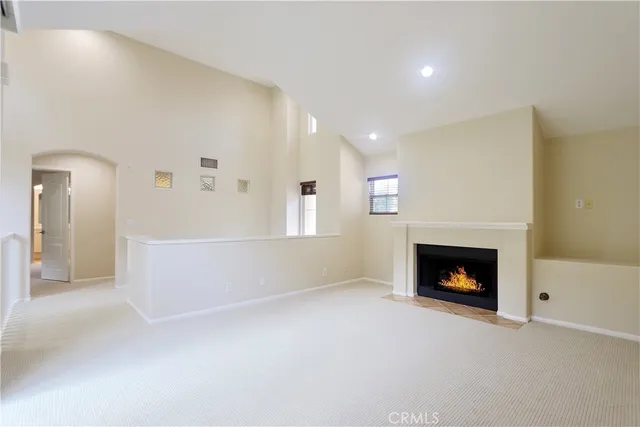 a view of an empty room with a fireplace