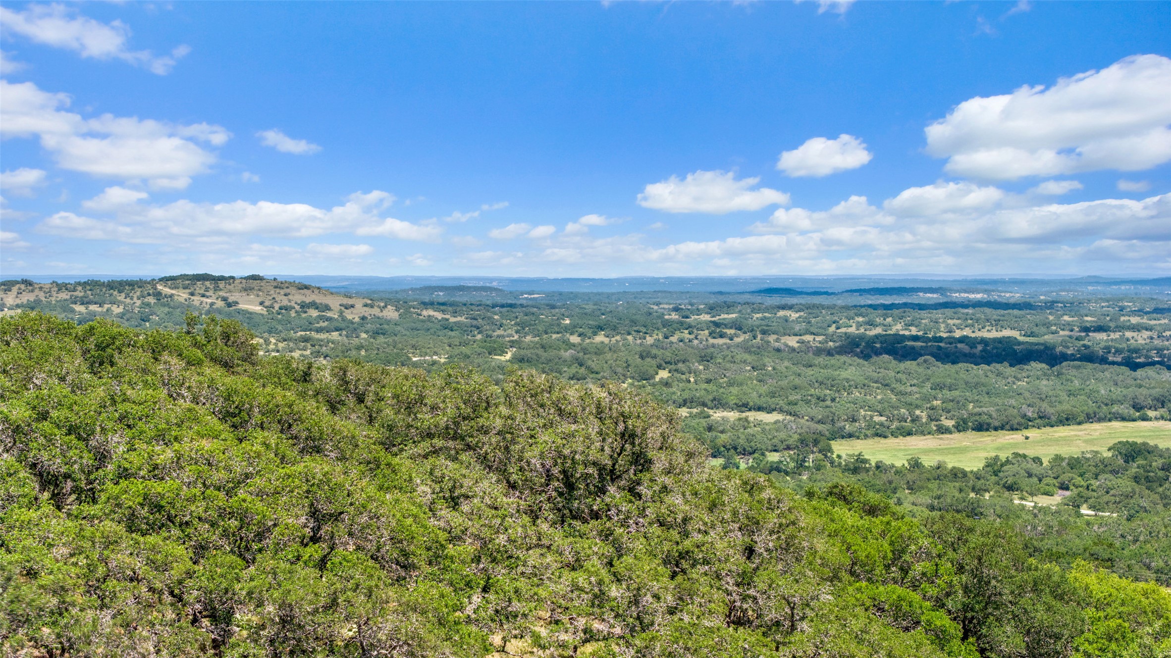 Tbd Kendalia Road Blanco, TX 78606 - Photo 18 of 24 a view of a city with lush green forest