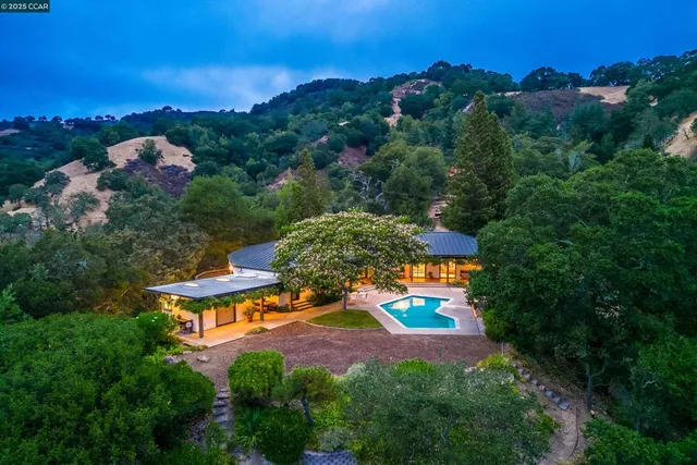 an aerial view of residential houses with outdoor space and street view