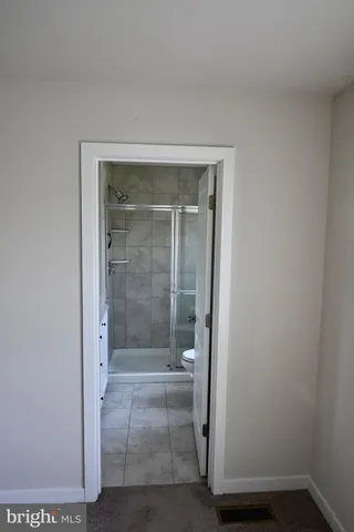 a bathroom with a sink and mirror with bathtub