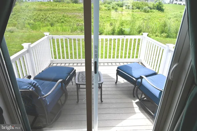 a view of a city from a chairs in the roof deck