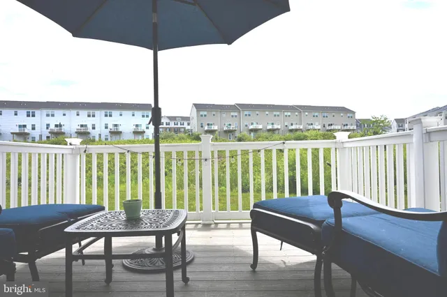 a view of a house and wooden deck