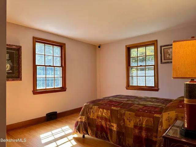 a bed sitting in a bedroom next to a window