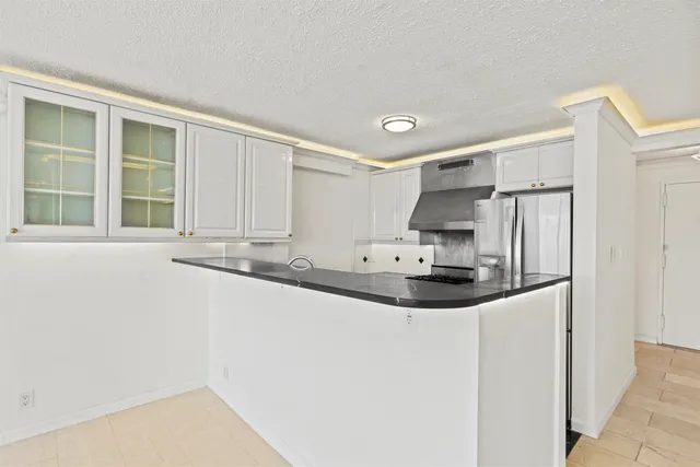 a kitchen with stainless steel appliances a sink and a refrigerator