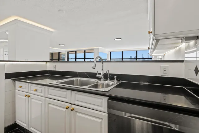 a kitchen with a sink and a stove top oven