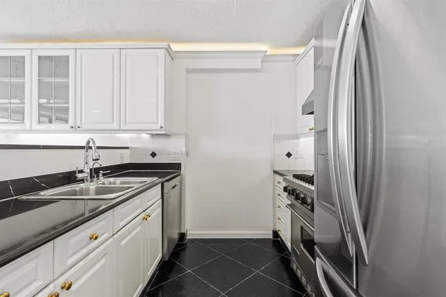 a kitchen with a sink and a refrigerator