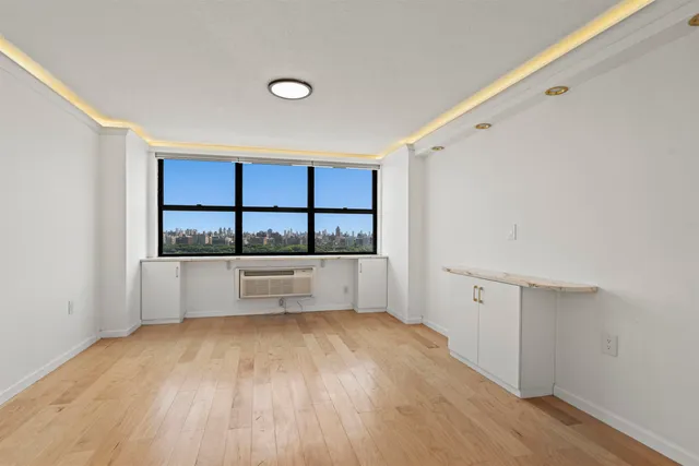 a view of room with window and wooden floor