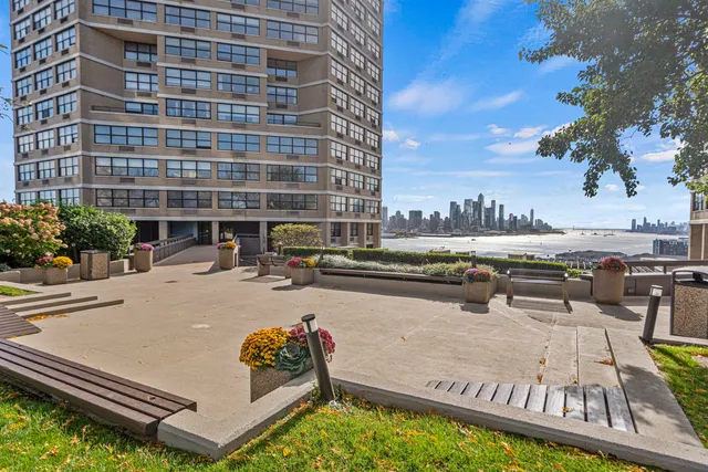 a view of a swimming pool with outdoor seating and plants