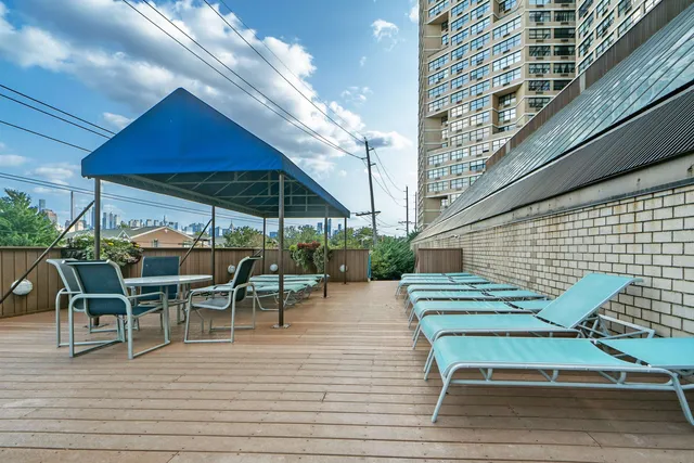 a view of a swimming pool with outdoor seating