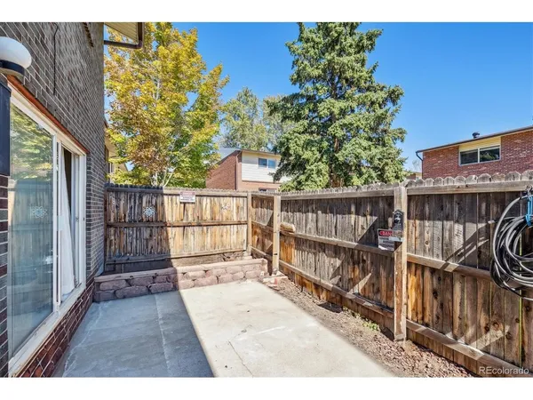 a view of balcony with wooden floor and fence
