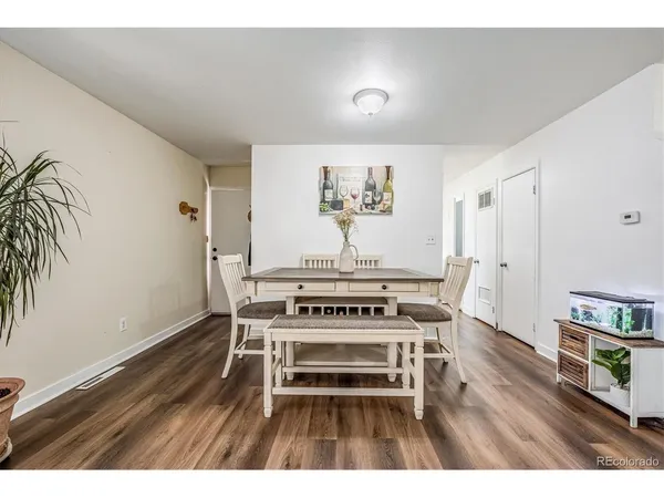 a view of a workspace with furniture and wooden floor