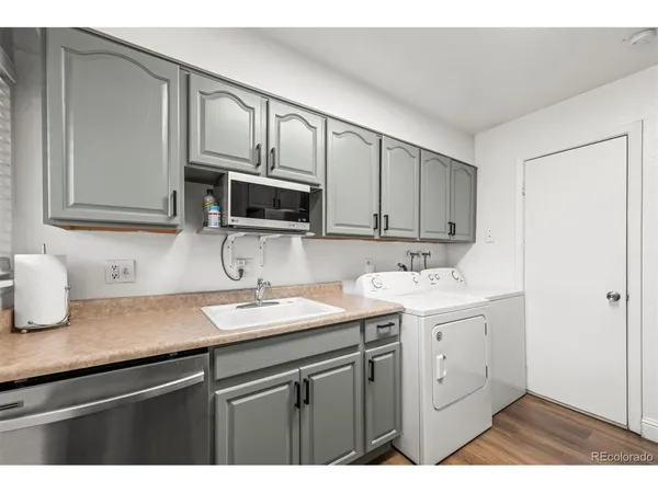 a kitchen with a sink stove and microwave