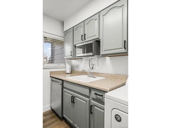a kitchen with stainless steel appliances granite countertop a sink and cabinets