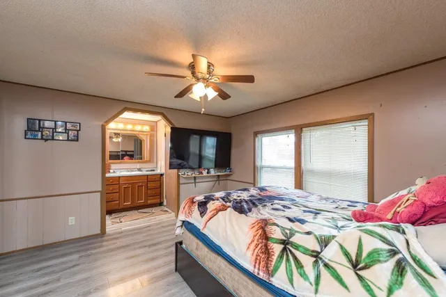 a bed sitting in a bedroom next to a window