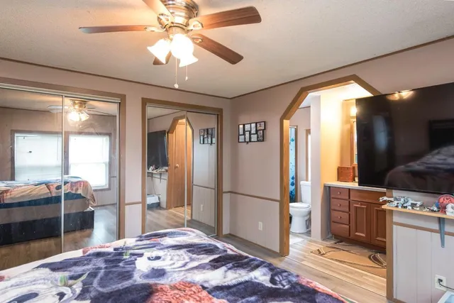 a bedroom with a bed and a chandelier