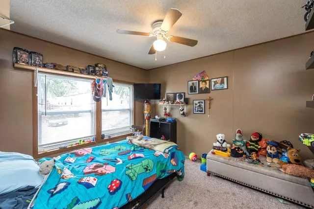 a bedroom with bed and a chandelier