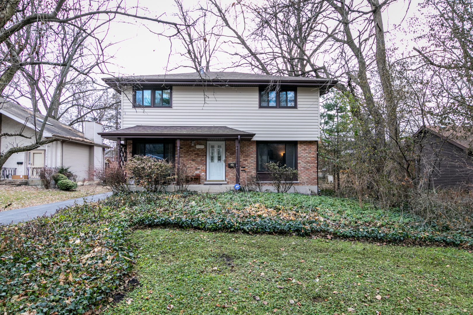 a front view of a house with a garden