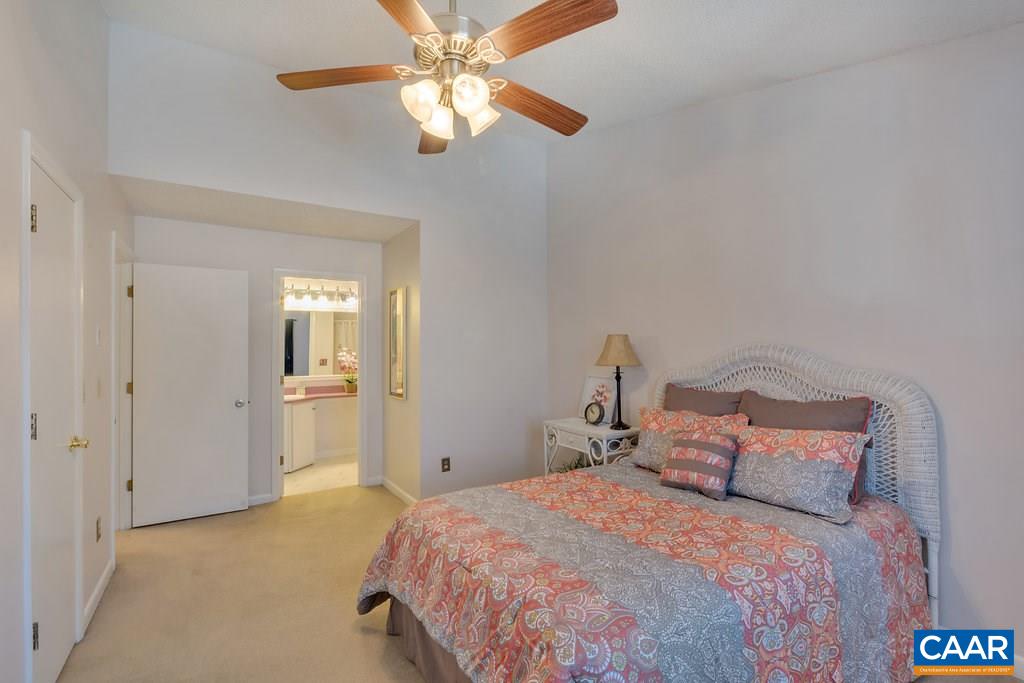 101 Turtle Creek Road, Unit 12 Charlottesville, VA 22901 - Photo 13 of 36 a bedroom with a bed and a chandelier