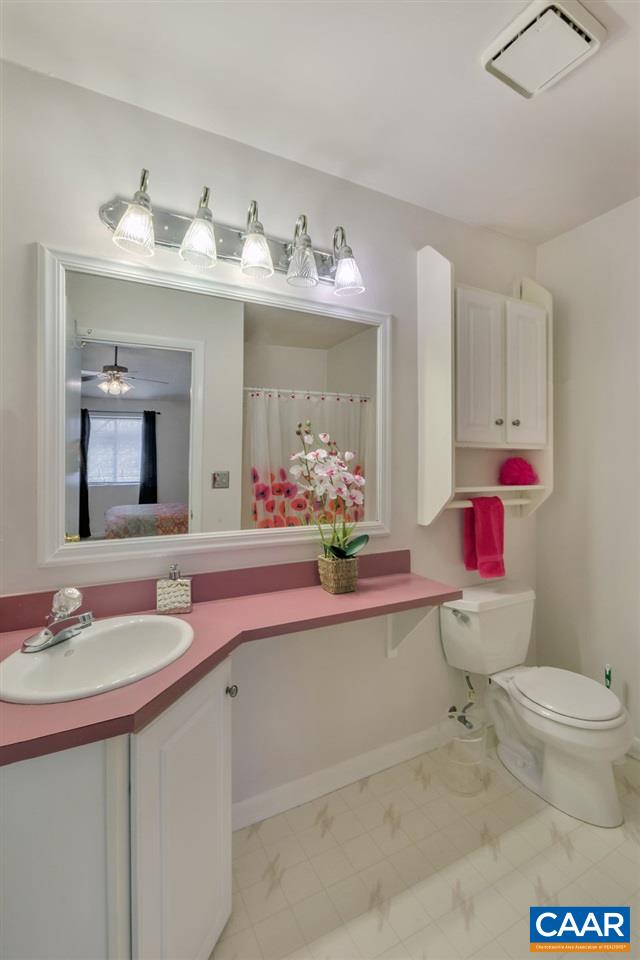 101 Turtle Creek Road, Unit 12 Charlottesville, VA 22901 - Photo 15 of 36 a bathroom with a sink vanity mirror and toilet