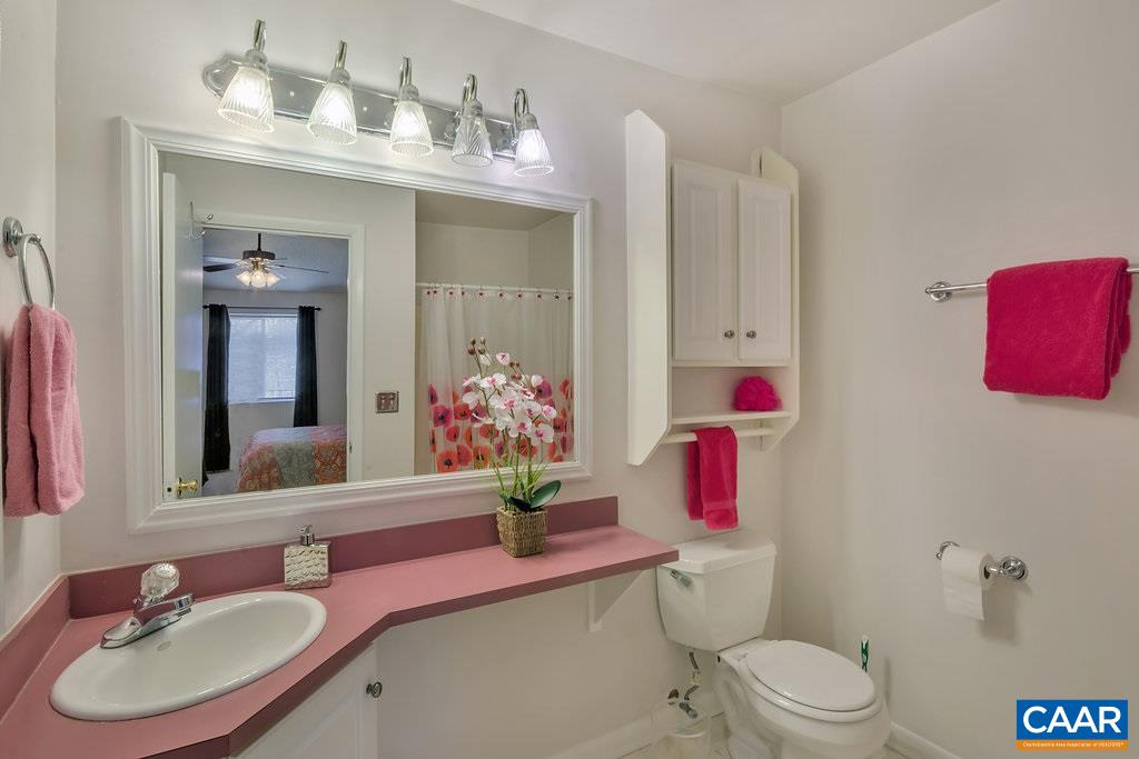 101 Turtle Creek Road, Unit 12 Charlottesville, VA 22901 - Photo 16 of 36 a bathroom with a sink vanity mirror and toilet