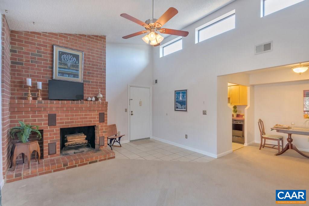101 Turtle Creek Road, Unit 12 Charlottesville, VA 22901 - Photo 4 of 36 a living room with furniture a fireplace and a flat screen tv